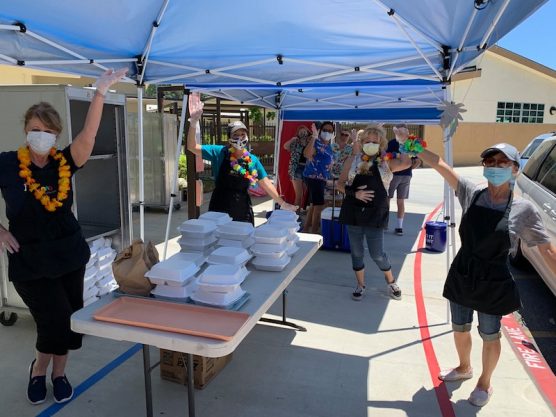 Volunteers giving out free meals to children during distance learning.